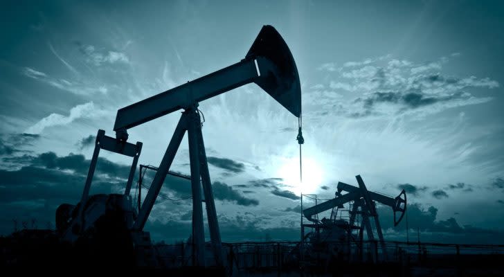 Image of an oil wells with a dark blue sky