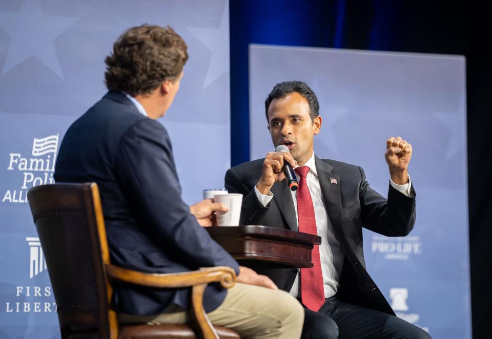 Republican presidential candidate and businessman Vivek Ramaswamy talks with moderator Tucker Carlson, left, during the Family Leadership Summit in Des Moines, Friday, July 14, 2023. 