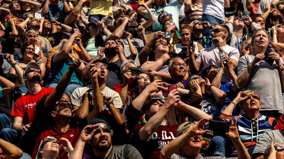 People look at the sky at Saluki Stadium during the total solar eclipse in Carbondale, Illinois (Evelyn Hockstein / Reuters)