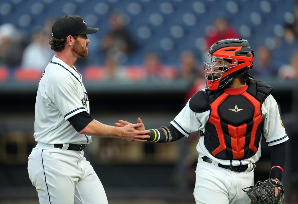 Cleveland Guardians pitcher Shane Bieber, left, celebrates with Akron RubberDucks catcher Micael Ramirez during a minor league game Sept. 12, 2023, in Akron.