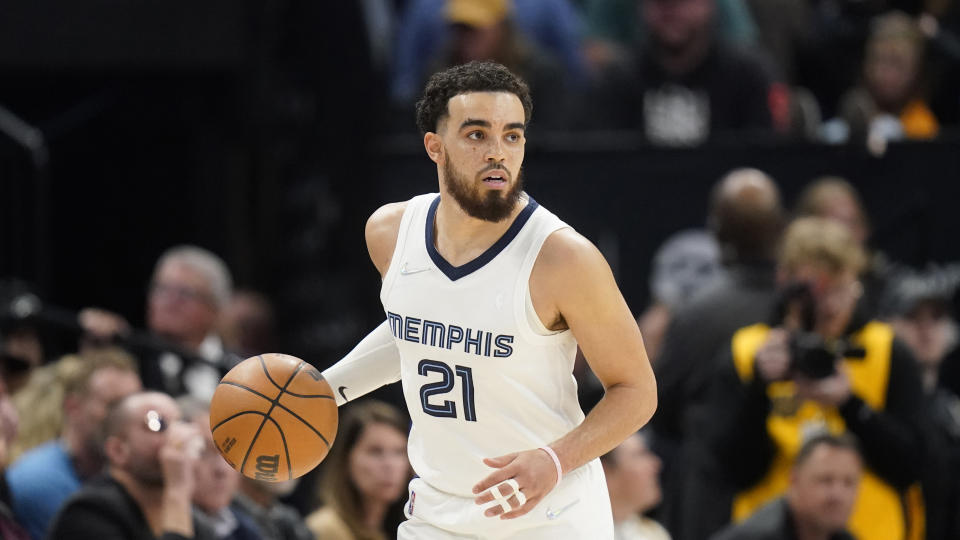 Memphis Grizzlies guard Tyus Jones (21) brings the ball up court during the second half of an NBA basketball game 