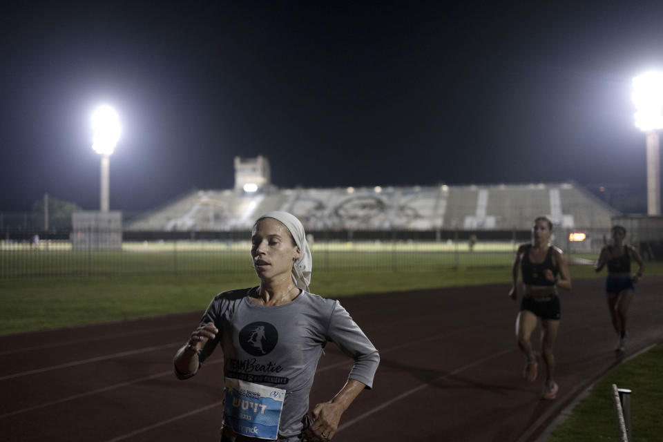 Beatie Deutsch, an Orthodox Jewish runner, trains in Tel Aviv, Israel, Wednesday, June 26, 2024. "I'd love governing bodies of sports to do more to accommodate religion," said the 34-year-old mother of five. She qualified to represent Israel in the 2020 Tokyo Olympics but didn't compete because the women's marathon was scheduled for a Saturday, when she observes shabbat. (AP Photo/Maya Alleruzzo)