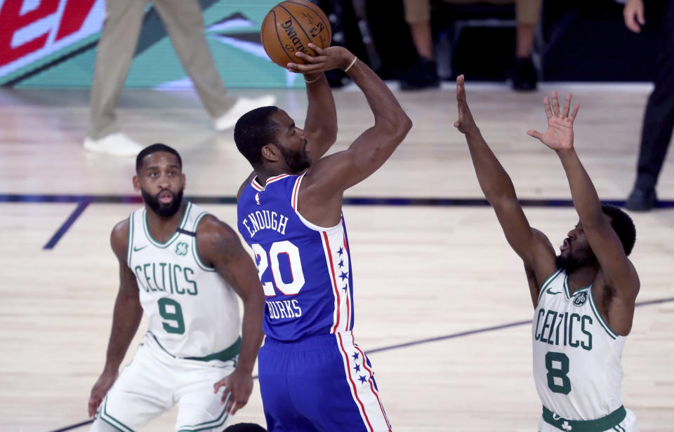 Philadelphia 76ers guard Alec Burks (20) shoots over Boston Celtics guard Kemba Walker (8) during the first quarter of Game 4 of an NBA basketball first-round playoff series, Sunday, Aug. 23, 2020, in Lake Buena Vista, Fla. (Kim Klement/Pool Photo via AP)