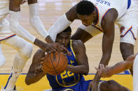 Golden State Warriors forward Andrew Wiggins, bottom, passes the ball as New York Knicks guard RJ Barrett, top right, defends during the first half of an NBA basketball game in San Francisco, Thursday, Jan. 21, 2021. (AP Photo/Jeff Chiu)