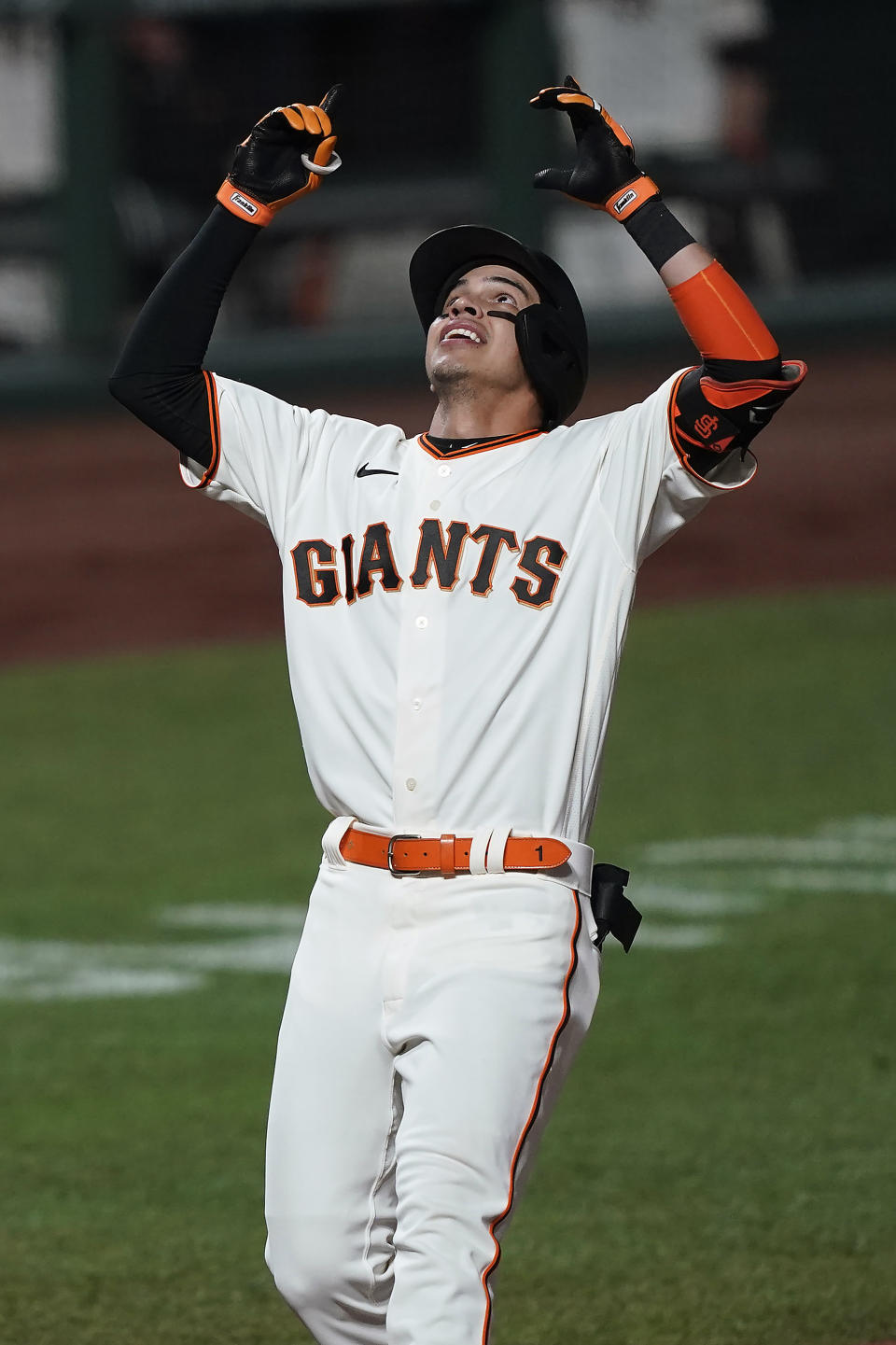 San Francisco Giants' Mauricio Dubon points to the sky as he crosses home plate after hitting a three-run home run against the Colorado Rockies during the fifth inning of a baseball game Wednesday, Sept. 23, 2020, in San Francisco. (AP Photo/Tony Avelar)