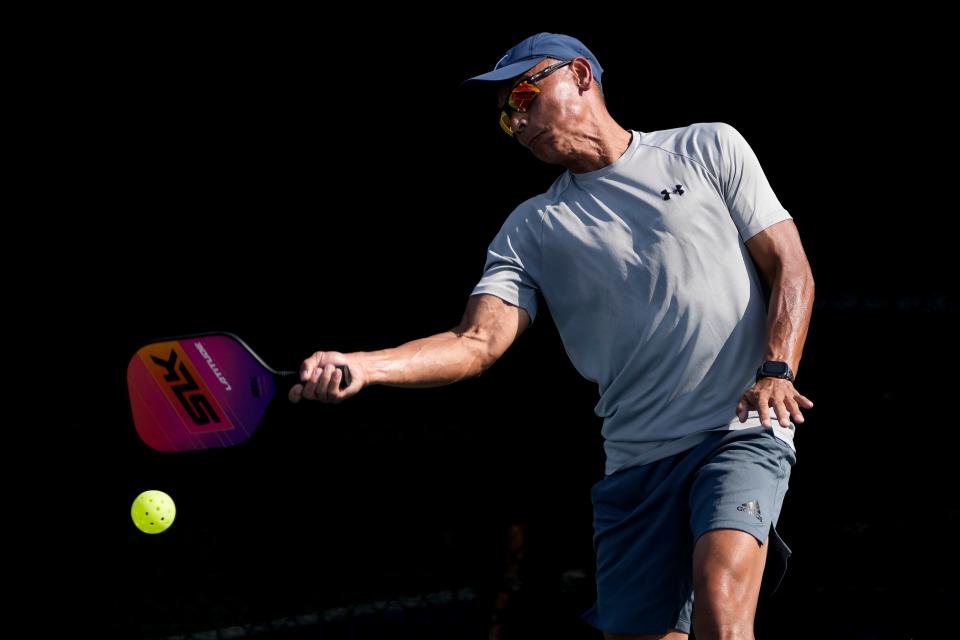 Jay Nguyen returns a shot as he plays pickleball during the grand opening of the New Albany Pickleball Complex in Bevelhymer Park on July 11.