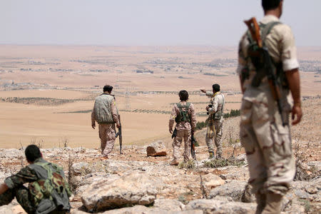 FILE PHOTO: Fighters of the Manbij military council, take an overwatch position in the southern rural area of Manbij, in Aleppo Governorate, Syria June 1, 2016. REUTERS/Rodi Said/File Photo