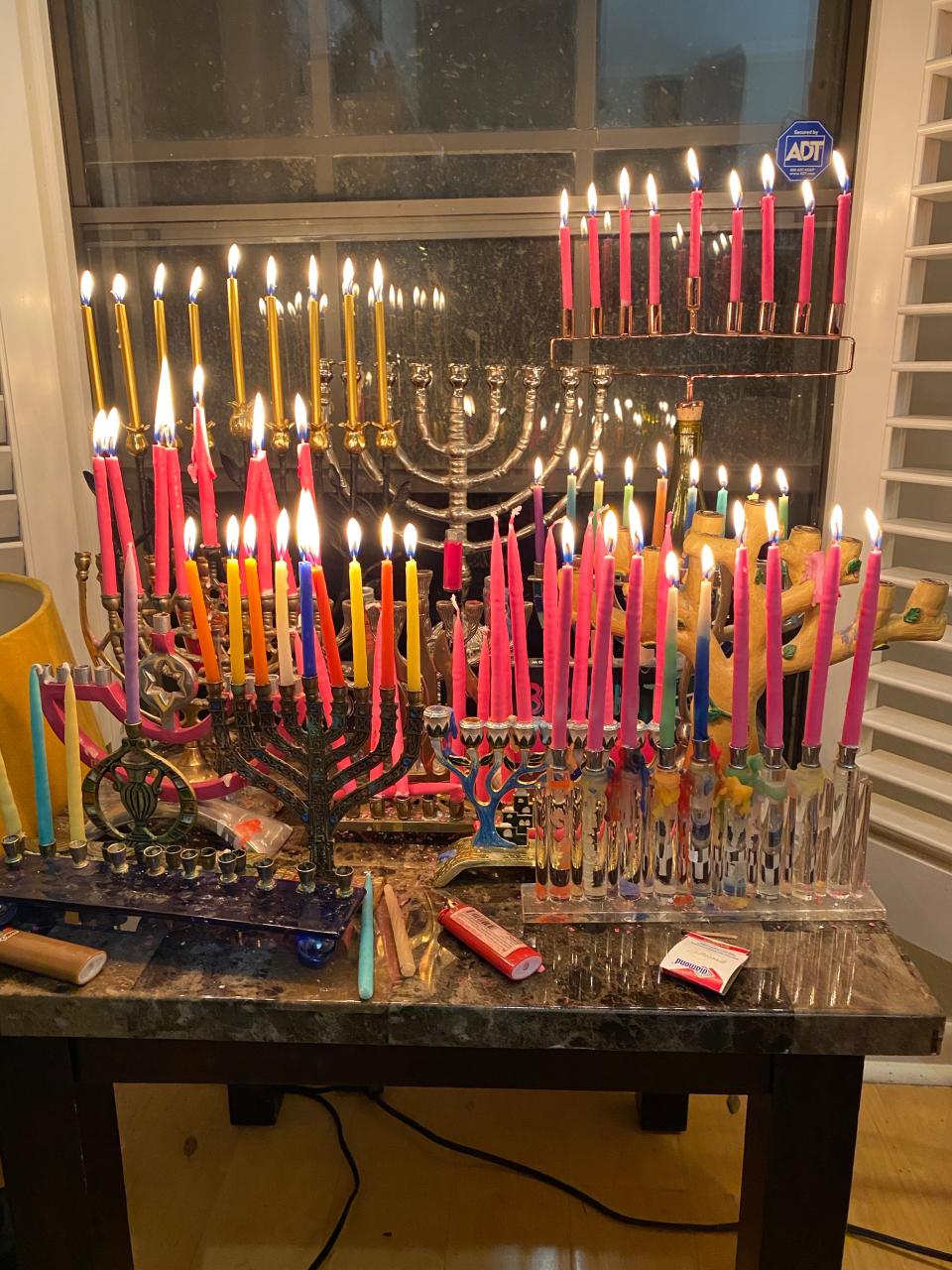 Chris Aguero, the principal of the Austin Jewish Academy, collects hannukiot, or menorahs, and lights them as part of his family's holiday decorations. These menorahs are placed in front of the window as part of the Hanukkah tradition to advertise the miracle the holiday celebrates.