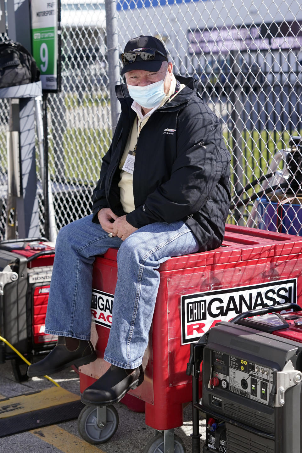 Chip Ganassi, owner of Chip Ganassi Racing, takes a break outside his pit stall during a practice session for the Rolex 24 hour race at Daytona International Speedway, Friday, Jan. 29, 2021, in Daytona Beach, Fla. (AP Photo/John Raoux)
