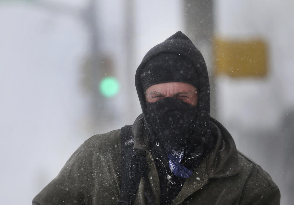 James Little closes his eyes against blowing snow during a blizzard on Wednesday, March 13, 2019, in Cheyenne, Wyo. Heavy snow hit Cheyenne about mid-morning Wednesday and was spreading into Colorado and Nebraska. (Jacob Byk/The Wyoming Tribune Eagle via AP)