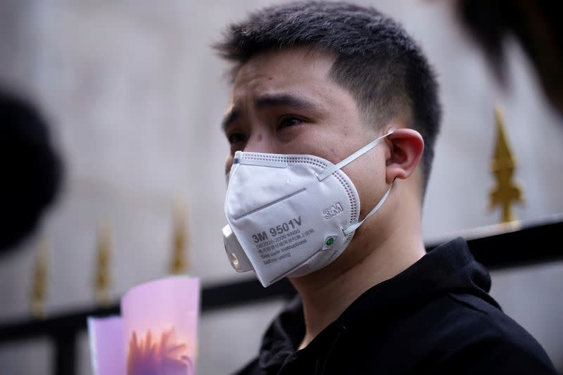 A man wearing a face mask cries in Wuhan