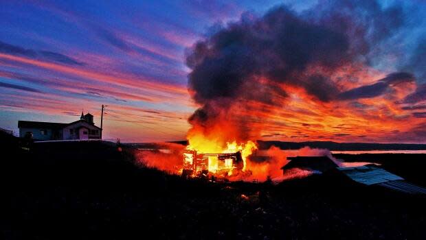 A home in Tsiigehtchic, N.W.T. was completely destroyed by flames early Saturday morning, according to community's fire chief, Albert Ross.  (Submitted by Lawrence Norbert - image credit)