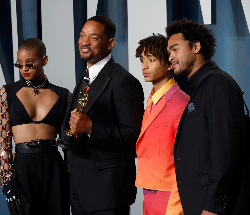 the Smith family posing together on the Oscars red carpet