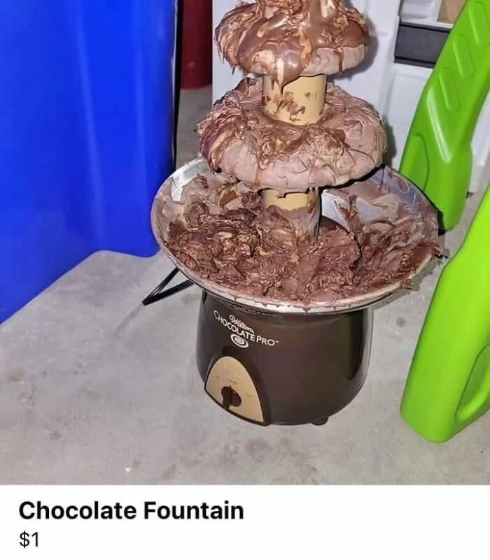 Chocolate fountain overflowing with chocolate, displayed on a dirty countertop. Text below reads "Chocolate Fountain $1"