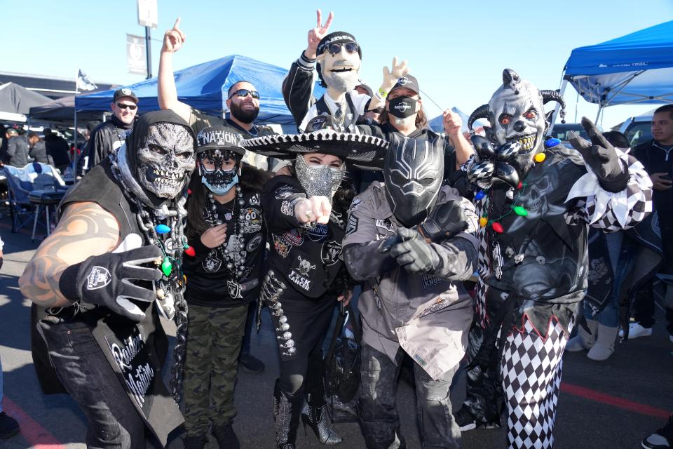 Raiders fans tailgate before the game against the Broncos.