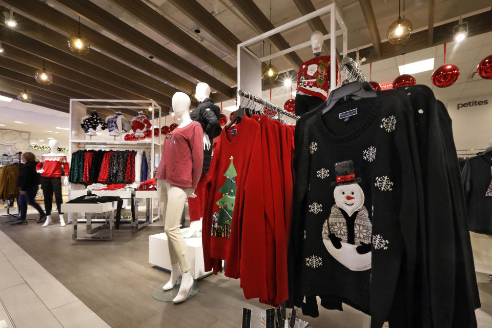 In this Tuesday, Nov. 5, 2019, photo browse holiday-themed clothing in the women's department at the Macy's flagship store in New York. With three weeks until the official start of the holiday shopping season, the nation’s retailers are gearing up for what will be another competitive shopping period. (AP Photo/Richard Drew)