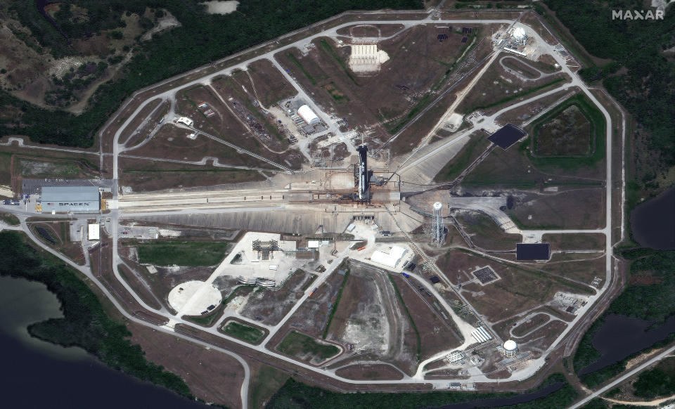 This photo provided by Maxar’s WorldView-3 satellite shows an overview of Launch Pad 39A and the SpaceX Falcon 9 rocket with the Crew Dragon spacecraft on top of the rocket, Saturday, May 23, 2020, at Kennedy Space Center, in Florida. NASA is preparing for its first manned flight in nearly a decade from the United States. (Satellite image ©2020 Maxar Technologies via AP)