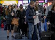 Holiday travelers wait for trains to be called at Penn Station in New York, November 26, 2014. REUTERS/Brendan McDermid