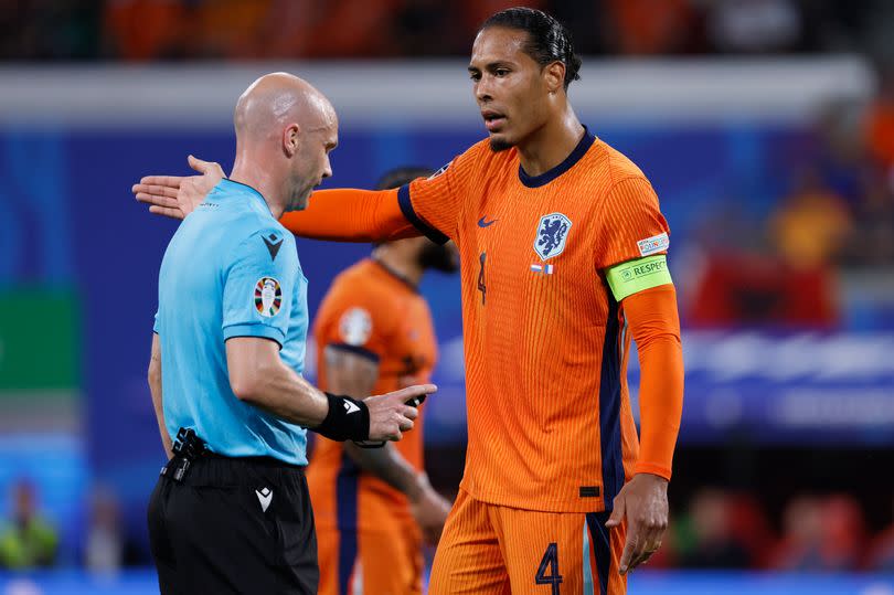 Referee Anthony Taylor and Virgil van Dijk during the UEFA EURO 2024 group stage match between Netherlands and France.