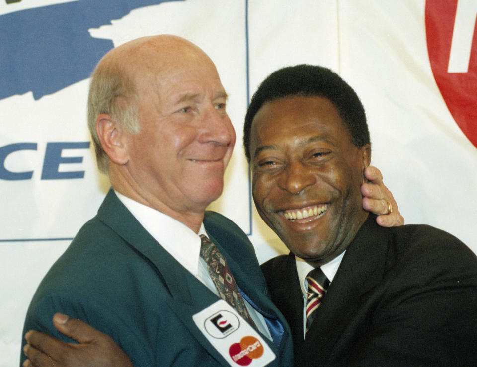 FILE - Soccer stars Sir Bobby Charlton of England, left, and Edson Arantes do Nascimento, known as Pele, of Brazil, are shown during the MasterCard International meeting in Paris, Feb. 9, 1995. Bobby Charlton, an English soccer icon who survived a plane crash that decimated a Manchester United team destined for greatness to become the heartbeat of his country's 1966 World Cup-winning team, has died. He was 86. A statement from Charlton's family, released by United, said he died Saturday Oct. 21, 2023 surrounded by his family. (AP Photo/Remy de la Mauviniere, file)