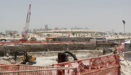 Bulldozers operate on a road under construction near Doha Towers June 25, 2013. REUTERS/Mohammed Dabbous/File Photo