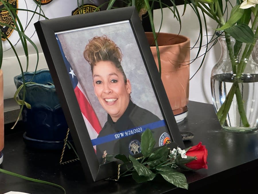 A photograph of Officer Christine Guerin Sandoval on display at the Pueblo County Sheriff's Office.