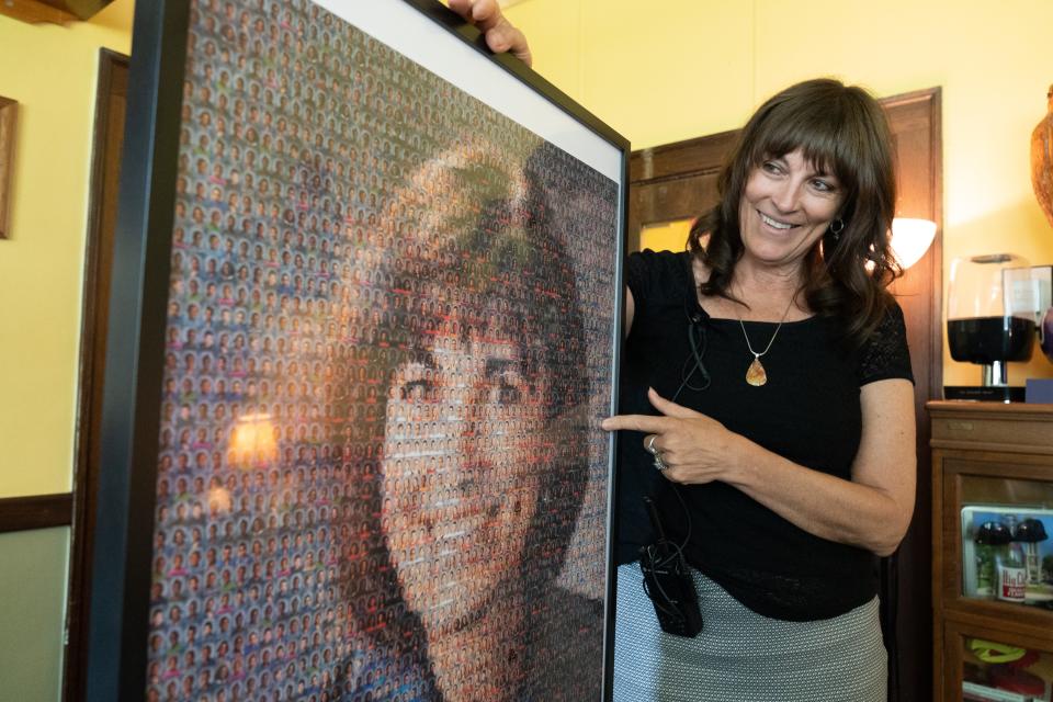 Topeka High principal Rebecca Morrisey points to a collage made from photos of former students from her time at Eisenhower Middle School.