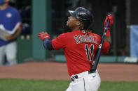 Cleveland Indians' Jose Ramirez watches his RBI sacrifice fly in the fifth inning of the team's baseball game against the Chicago Cubs, Wednesday, Aug. 12, 2020, in Cleveland. (AP Photo/Tony Dejak)