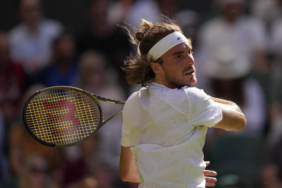 Stefanos Tsitsipas of Greece returns to Britain's Andy Murray in a men's singles match on day five of the Wimbledon tennis championships in London, Friday, July 7, 2023. (AP Photo/Alberto Pezzali)