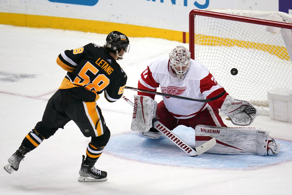 Detroit Red Wings goaltender Calvin Pickard (31) stops a shot by Pittsburgh Penguins' Kris Letang (58) to win a shootout in an NHL hockey game in Pittsburgh, Friday, Jan. 28, 2022. (AP Photo/Gene J. Puskar)