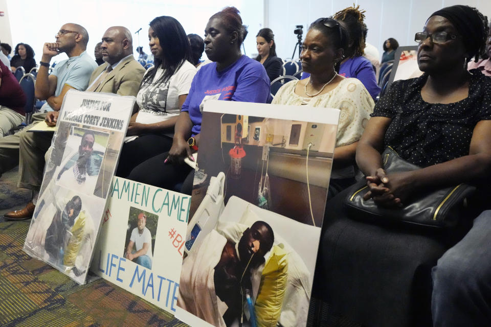The families of Michael Corey Jenkins and Damien Cameron sit together during the Justice Department's Civil Rights Division tour Thursday, June 1, 2023, in during a Jackson, Miss. Six white former law enforcement officers in Mississippi who called themselves the “Goon Squad” pleaded guilty Thursday, Aug. 3, 2023, to a racist assault on the two Black men in a home raid that ended with an officer shooting one man in the mouth. (AP Photo/Rogelio V. Solis, File)