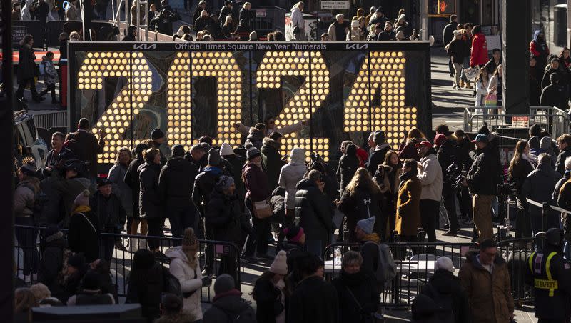 People gather around the 2024 New Year’s Eve numerals displayed in Times Square on Dec. 20, 2023, in New York.