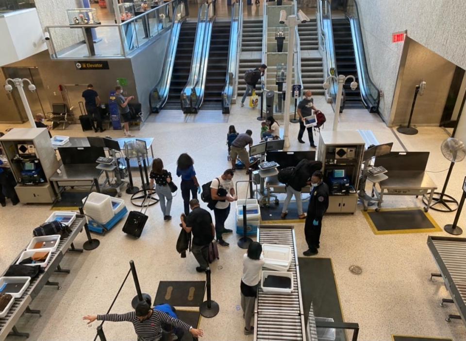 Passengers pass through TSA at New York's JFK airport