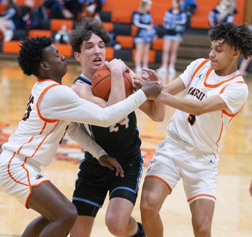 Louisville's Hayden Nigro is tied up by Massillon defenders Jadyce Thigpen, left, and Chris Knight in the first half, Tuesday, Feb. 14, 2023.