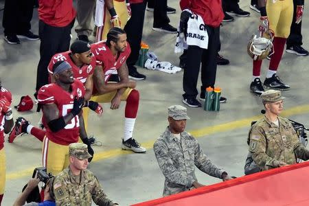 FILE PHOTO: San Francisco 49ers quarterback Colin Kaepernick and teammate 49ers free safety Eric Reid (35) kneel during the playing of the national anthem before a NFL game against the Los Angeles Rams in Santa Clara, California, Sep 12, 2016. Mandatory Credit: Kirby Lee-USA TODAY Sports/File Photo