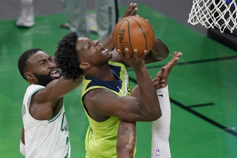 Minnesota Timberwolves forward Anthony Edwards goes up to shoot against the defense of Boston Celtics guard Jaylen Brown, left, in the first quarter of an NBA basketball game, Friday, April 9, 2021, in Boston. (AP Photo/Elise Amendola)