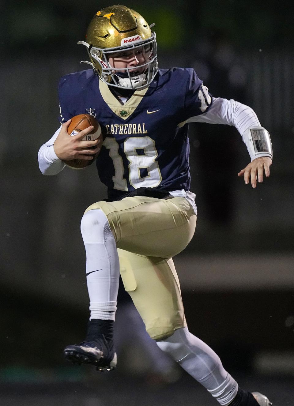 Cathedral Fighting Irish quarterback Danny O'Neil (18) rushes up the field Friday, Nov 18, 2022 at Arsenal Technical High School in Indianapolis. Center Grove Trojans defeated the Cathedral Fighting Irish, 33-10, for the semistate championship. 