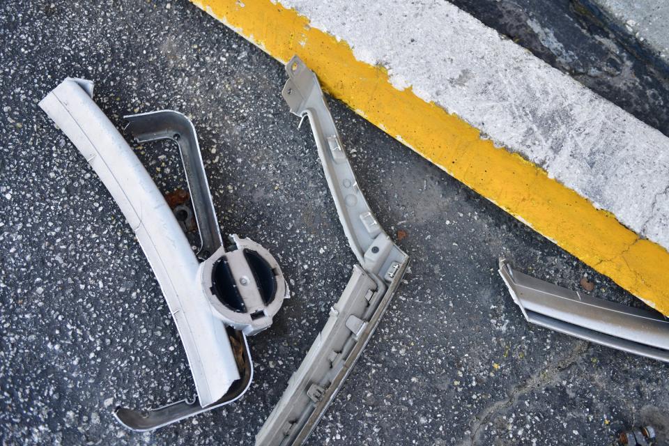 Broken car parts are still scattered on the asphalt outside Bennett's Ace Hardware, days after a semi crashed through its front wall late Friday, injuring five people including two children and the store's owners.