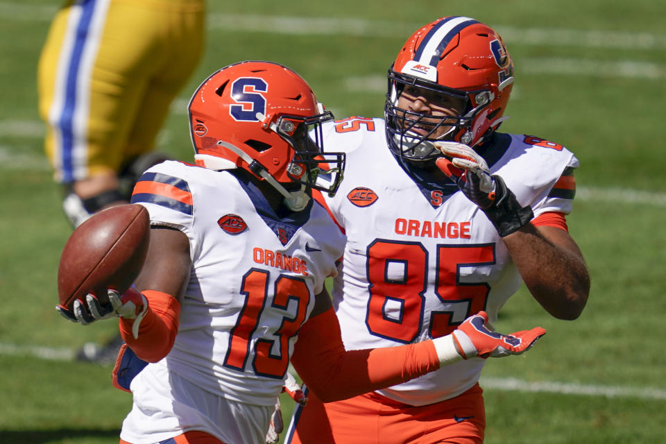 Syracuse linebacker Mikel Jones (13) celebrates with Josh Black (85) after recovering a fumble when Pittsburgh running back Vincent Davis (22) missed a backward pass during the first half of an NCAA college football game, Saturday, Sept. 19, 2020, in Pittsburgh. (AP Photo/Keith Srakocic)