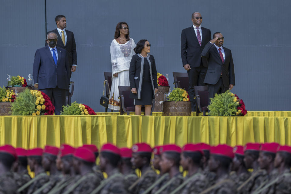 Ethiopia's Prime Minister Abiy Ahmed, right, First Lady Zinash Tayachew, center, and Djibouti's President Ismail Omar Guelleh, left, attend Abiy's inauguration ceremony after he was sworn in for a second five-year term, in the capital Addis Ababa, Ethiopia Monday, Oct. 4, 2021. Abiy was sworn in Monday for a second five-year term running a country in the grip of a nearly year-long war, as a handful of visiting African leaders urged him to hold the nation together. (AP Photo/Mulugeta Ayene)