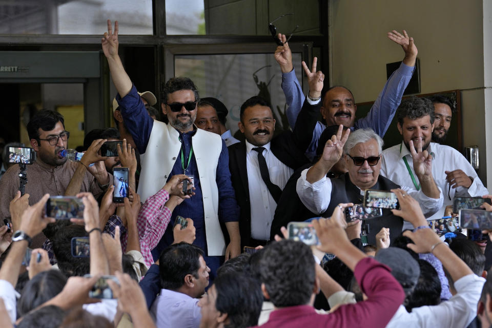 Supporters of imprisoned former Prime Minister Imran Khan's party Tehreek-e-Insaf, react after a Supreme Court decision in a case of reserved seats for women and minorities in the parliament, in Islamabad, Pakistan, Friday, July 12, 2024. Pakistan's top court on Friday ruled that the party of imprisoned former Prime Minister Khan is eligible for seats reserved in the parliament, a major blow to the country's weak coalition government. (AP Photo/Anjum Naveed)