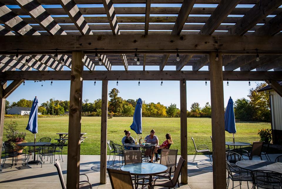 Customers use the outdoor seating area at Tonne Winery Wednesday, Oct. 7, 2020. 