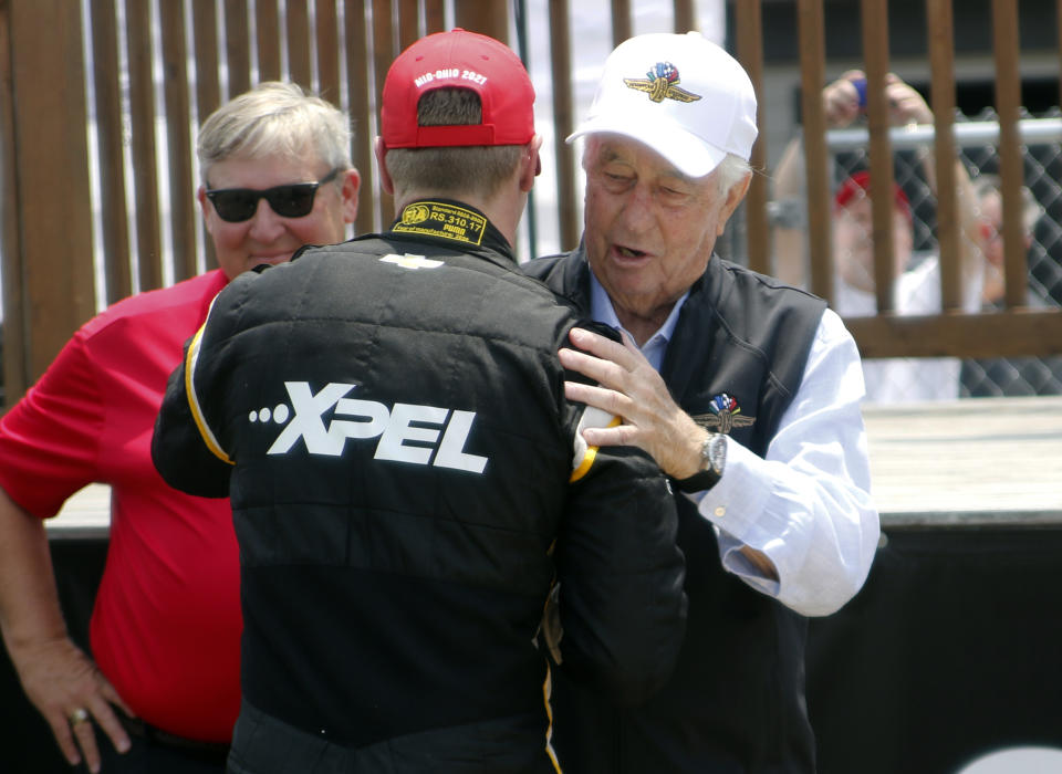 Car owner Roger Penske, right, congratulates Josef Newgarden in victory lane after winning an IndyCar race at Mid-Ohio Sports Car Course in Lexington, Ohio, Sunday, July 4, 2021. (AP Photo/Tom E. Puskar)