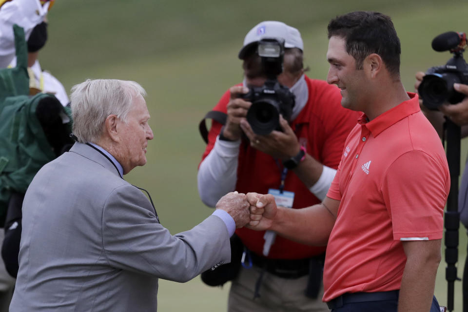 Jon Rahm, of Spain, right, is congratulated by Jack Nicklaus after winning the Memorial golf tournament, Sunday, July 19, 2020, in Dublin, Ohio. (AP Photo/Darron Cummings)
