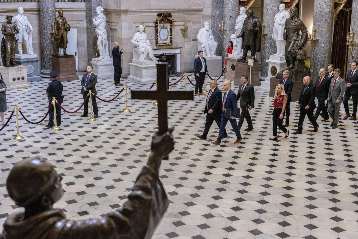 From left: House Sergeant at Arms William McFarland and House Clerk Kevin McCumber walk with impeachment managers carrying the articles of impeachment against Alejandro Mayorkas, secretary of the Department of Homeland Security, in a ceremonial procession across the U.S. Capitol in Washington, on Tuesday, April 16, 2024. (Anna Rose Layden/The New York Times)