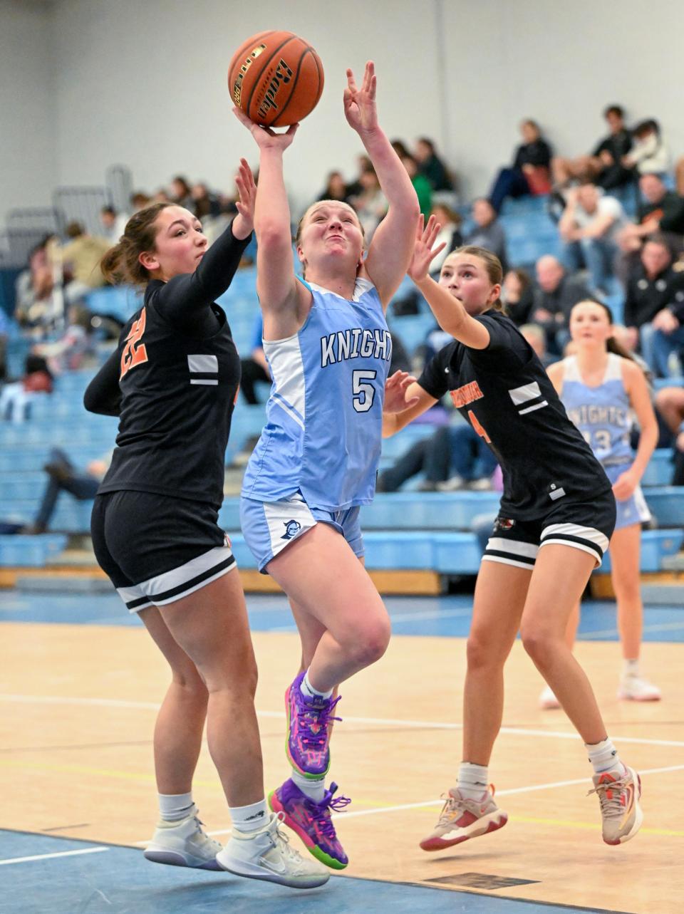 Aubrie Schwager of Sandwich goes to the hoop between Amanda Cardin and Jessica Perry of Middleborough.
