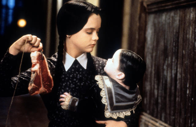 Christina Ricci dangling meat in a scene from the film 'Addams Family Values', 1993. (Photo by Paramount/Getty Images)