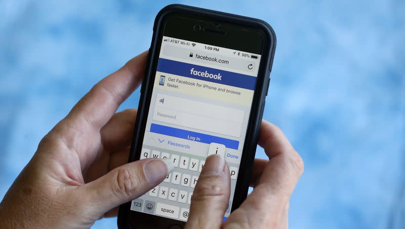 In this Aug. 21, 2018, file photo, a Facebook start page is shown on a smartphone in Surfside, Fla.