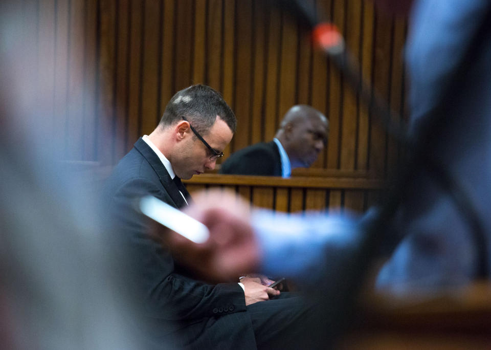Oscar Pistorius, on his arrival in court for his ongoing murder trial in Pretoria, South Africa, Tuesday, May 13, 2014. Pistorius is charged with the shooting death of his girlfriend Reeva Steenkamp on Valentine's Day in 2013. (AP Photo/Daniel Born, Pool)
