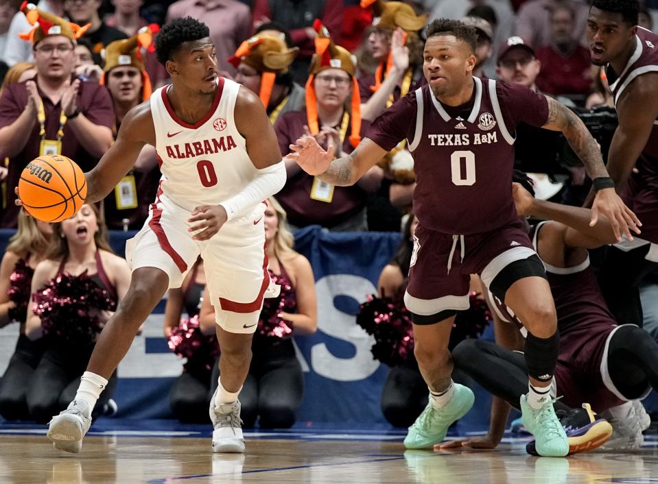 Alabama guard Jaden Bradley moves the ball while defended by Texas A&M's Dexter Dennis during the SEC Men’s Basketball Tournament championship game Sunday at Bridgestone Arena in Nashville, Tenn.